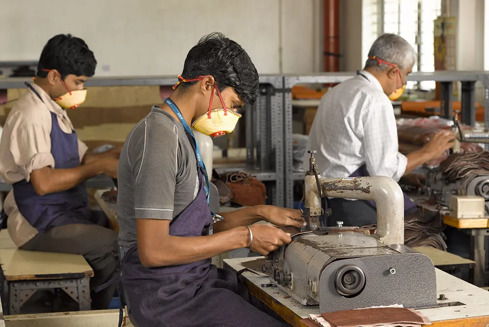 Leather artisan working carefully on leather goods